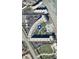 Aerial view showing the condo building, pool, parking, and surrounding landscape at 4501 S Atlantic Ave # 4090, New Smyrna Beach, FL 32169