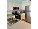 Kitchen with stainless steel appliances and white cabinets at 4501 S Atlantic Ave # 4090, New Smyrna Beach, FL 32169