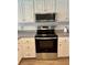 Stainless steel appliances and white cabinets in this updated kitchen at 4501 S Atlantic Ave # 4090, New Smyrna Beach, FL 32169