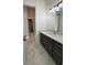 Vanity with dark brown cabinets, quartz countertop, and marble floor at 547 Sanctuary Golf Pl, Apopka, FL 32712