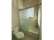 Bathroom with shower/tub combo, glass sliding door, and marble tile at 547 Sanctuary Golf Pl, Apopka, FL 32712