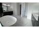 Elegant bathroom featuring a free-standing tub and dark wood vanity at 547 Sanctuary Golf Pl, Apopka, FL 32712