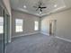 Spacious bedroom with gray carpet, ceiling fan, and large windows at 547 Sanctuary Golf Pl, Apopka, FL 32712