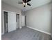 Bedroom with gray carpet, ceiling fan and spacious closet at 547 Sanctuary Golf Pl, Apopka, FL 32712