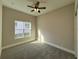 Bedroom with gray carpet, ceiling fan, and large window at 547 Sanctuary Golf Pl, Apopka, FL 32712