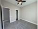 Bright bedroom with gray carpet, ceiling fan and closet at 547 Sanctuary Golf Pl, Apopka, FL 32712