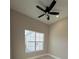 Bright bedroom with ceiling fan, large window, and light gray floors at 547 Sanctuary Golf Pl, Apopka, FL 32712