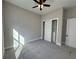 Bedroom with gray carpet, ceiling fan, and spacious closet at 547 Sanctuary Golf Pl, Apopka, FL 32712