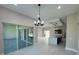 Bright dining area with sliding glass doors leading to the patio, chandelier, and tile flooring at 547 Sanctuary Golf Pl, Apopka, FL 32712