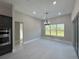 Bright dining room with large window and access to the kitchen at 547 Sanctuary Golf Pl, Apopka, FL 32712