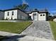 Modern two-story home with gray paver driveway and landscaped lawn at 547 Sanctuary Golf Pl, Apopka, FL 32712