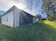 View of the house exterior showcasing a screened patio and grassy yard at 547 Sanctuary Golf Pl, Apopka, FL 32712