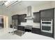 Modern kitchen with stainless steel appliances and dark wood cabinets at 547 Sanctuary Golf Pl, Apopka, FL 32712