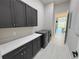 Laundry room with dark cabinets, white countertop, and washer/dryer at 547 Sanctuary Golf Pl, Apopka, FL 32712