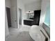 Elegant main bathroom with dark vanity, marble floors, and free-standing tub at 547 Sanctuary Golf Pl, Apopka, FL 32712