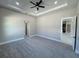 Large main bedroom with gray carpet, ceiling fan, and access to other rooms at 547 Sanctuary Golf Pl, Apopka, FL 32712