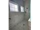 Large walk-in shower with marble tile and multiple shower heads at 547 Sanctuary Golf Pl, Apopka, FL 32712