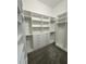 Bright walk-in closet with white shelving and drawers at 547 Sanctuary Golf Pl, Apopka, FL 32712