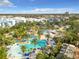 Large resort-style pool with palm trees, lounge chairs, and cabanas at 7405 Excitement Dr, Kissimmee, FL 34747