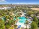 Expansive pool area with palm trees and numerous lounge chairs at 7405 Excitement Dr, Kissimmee, FL 34747