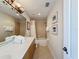 Clean bathroom with a double vanity, bathtub, and updated fixtures at 7405 Excitement Dr, Kissimmee, FL 34747
