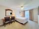 Comfortable bedroom with a desk, ceiling fan, and large window at 7405 Excitement Dr, Kissimmee, FL 34747