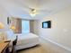 Bright bedroom with a comfortable bed, large TV and access to a balcony at 7405 Excitement Dr, Kissimmee, FL 34747