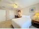 Charming bedroom with a comfortable bed, ceiling fan, and nightstands at 7405 Excitement Dr, Kissimmee, FL 34747