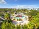 Community waterpark with slides, a sandy beach area, and lounge chairs at 7405 Excitement Dr, Kissimmee, FL 34747