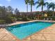 Community pool with lounge chairs and palm trees at 8300 Kelsall Dr, Orlando, FL 32832