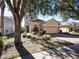 Two-story house with a tan exterior, landscaped yard, and a two-car garage at 8320 Via Bella Notte, Orlando, FL 32836