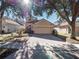Tan two-story house with a two-car garage and lush landscaping at 8320 Via Bella Notte, Orlando, FL 32836