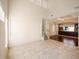 Spacious living room with high ceilings, tile floors, and a staircase at 8320 Via Bella Notte, Orlando, FL 32836