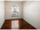 Bright home office space with hardwood floors and a large arched window at 8320 Via Bella Notte, Orlando, FL 32836