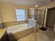 Bathroom features a soaking tub and walk-in shower at 9037 Shadow Mountain St, Davenport, FL 33896