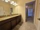 Double vanity bathroom with granite countertops and a walk-in shower at 9037 Shadow Mountain St, Davenport, FL 33896