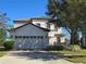 Two-story house with a three-car garage and manicured lawn at 9037 Shadow Mountain St, Davenport, FL 33896