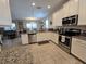 Spacious kitchen featuring granite countertops and stainless steel appliances at 9037 Shadow Mountain St, Davenport, FL 33896