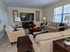 Spacious living room with ample seating and a large flat-screen TV at 9037 Shadow Mountain St, Davenport, FL 33896