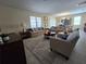 Relaxing living room with comfortable seating and a large window at 9037 Shadow Mountain St, Davenport, FL 33896