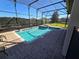 Inviting screened-in pool and spa with patio area at 9037 Shadow Mountain St, Davenport, FL 33896