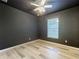 Bedroom with dark walls, wood flooring, and ceiling fan at 11114 Oakshore Ln, Clermont, FL 34711