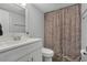 Bathroom with white vanity and floral shower curtain at 126 Scottsdale Sq # 126, Winter Park, FL 32792