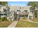 Exterior view of the building with stairs and landscaping at 126 Scottsdale Sq # 126, Winter Park, FL 32792