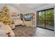 Spacious living room with tiled floors, a cozy couch, and access to a balcony at 126 Scottsdale Sq # 126, Winter Park, FL 32792