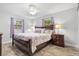 Main bedroom with wood framed bed, two nightstands, and window curtains at 134 Lake Harriet Dr, Altamonte Springs, FL 32714