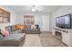 Living room with gray sectional sofa and electric fireplace at 134 Lake Harriet Dr, Altamonte Springs, FL 32714