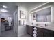 Modern bathroom with double vanity, large mirror, and walk-in shower at 14501 Grove Resort Ave # 2716, Winter Garden, FL 34787