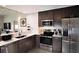 Modern kitchen with stainless steel appliances and granite countertops at 14501 Grove Resort Ave # 2716, Winter Garden, FL 34787