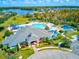 Community pool and clubhouse with surrounding landscape and lake at 17719 Lily Blossom Ln, Orlando, FL 32820